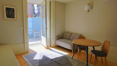 a living room with a table and a couch at Oporto Maison Palace in Porto