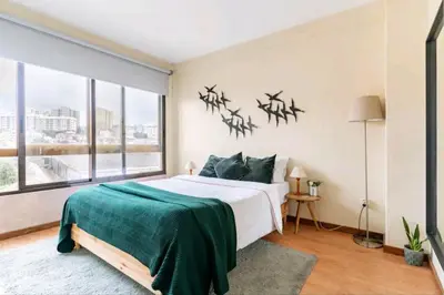 a bedroom with a large bed and a large window at Invictus Porto Apartment in Porto