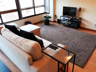 a living room with a couch and a television at Invictus Porto Apartment in Porto