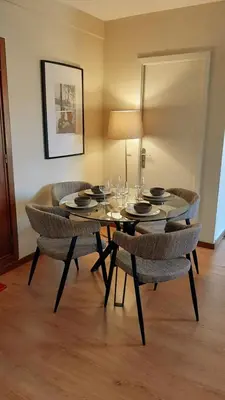 a dining room with a table and chairs with wine glasses at Invictus Porto Apartment in Porto