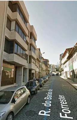 a street with cars parked on the side of the road at Invictus Porto Apartment in Porto