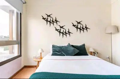 a bedroom with a bed with birds on the wall at Invictus Porto Apartment in Porto