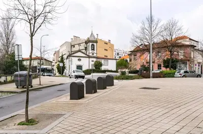 a city street with a row of barriers on the sidewalk at Invictus Porto Apartment in Porto