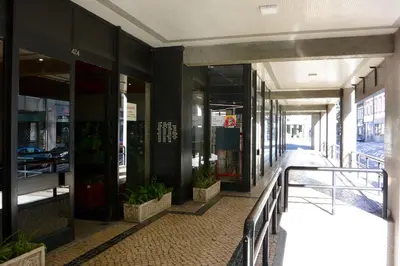 a hallway of a building with glass doors and plants at VB Porto City Studio, by Flat in Porto in Porto