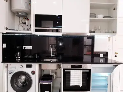 a kitchen with a washing machine and a washer at VB Porto City Studio, by Flat in Porto in Porto