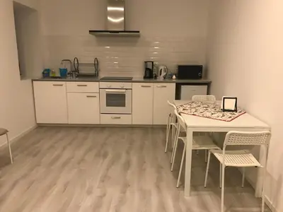 a kitchen with a table and chairs in a room at City Heart Place 4 in Porto