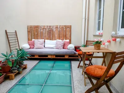 a patio with a couch and a table at Porto Main Square Penthouse Apartment in Porto