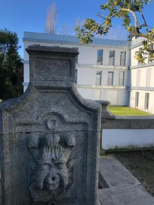 a stone monument in front of a building at BBA Apartments Palácio I - Douro View, Gym & Free Parking in Porto