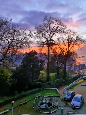 a sunset with cars parked in a parking lot at BBA Apartments Palácio I - Douro View, Gym & Free Parking in Porto