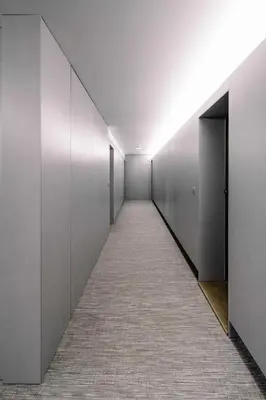 a corridor of an office building with white walls at BBA Apartments Palácio II - Garden View, Gym & Free Parking in Porto