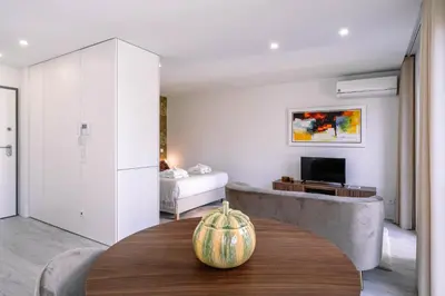 a living room with a table and a couch at BBA Apartments Palácio II - Garden View, Gym & Free Parking in Porto