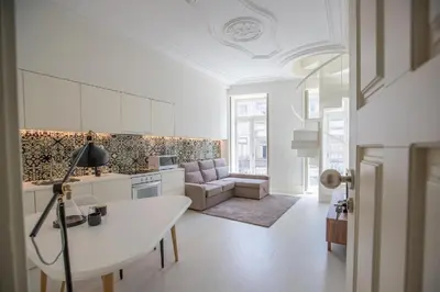 a kitchen and living room with a table and a couch at GuestReady - Porto D'Alma - Stª Catarina 1E in Porto