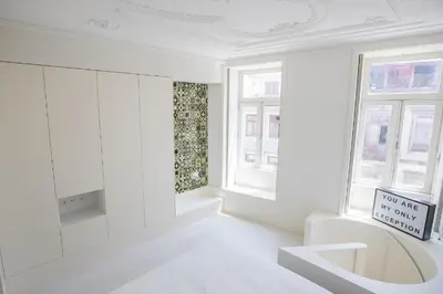 a white room with two windows and a sign at GuestReady - Porto D'Alma - Stª Catarina 1E in Porto