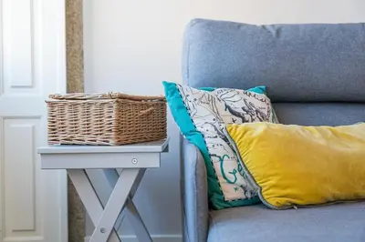 a wicker basket sitting on a table next to a chair at GuestReady - Cardosas Town Apartment in Porto