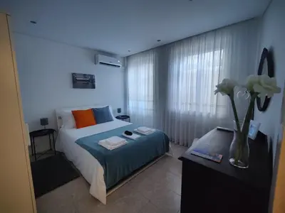 a bedroom with a bed and a vase of flowers at Casa da Rita in Porto