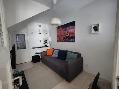 a living room with a couch with colorful pillows at Casa da Rita in Porto