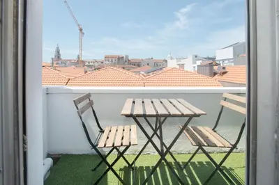 a kitchen with a wooden table in a room at Porto Automatic in Porto