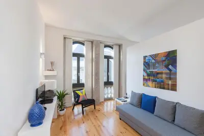 a living room with a couch and a tv at BO - Bolhão Apartments in Porto