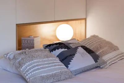 a bed with two pillows on top of it at Beautiful Loft Downtown Porto in Porto