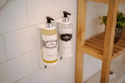 two bottles of cleaning products are hanging on a wall at Lovely Nest Downtown Porto in Porto
