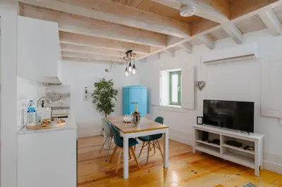 a kitchen and dining room with a table and chairs at Lovely Nest Downtown Porto in Porto