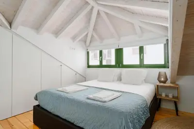 a bedroom with a bed with two towels on it at Lovely Nest Downtown Porto in Porto