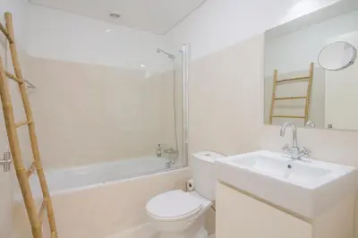 a bathroom with a toilet and a sink and a tub at Porto City Cottage in Ribeira neighborhood in Porto