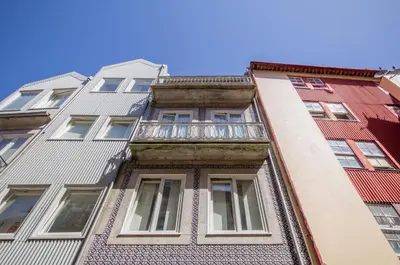a tall apartment building with a balcony at Porto City Cottage in Ribeira neighborhood in Porto