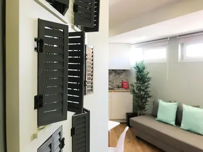 a wall of wine racks in a living room at Little Tower in Porto
