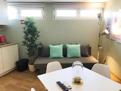 a living room with a couch with two pillows at Little Tower in Porto