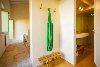 a green umbrella hanging on a wall in a room at Estúdio 22 na Boavista, JAMBA House in Porto