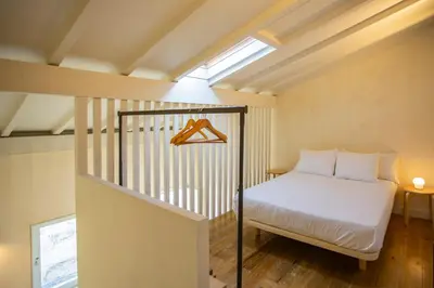 a small bedroom with a bed and a window at Estúdio 22 na Boavista, JAMBA House in Porto