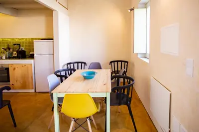 a kitchen and dining room with a table and chairs at Estúdio 22 na Boavista, JAMBA House in Porto