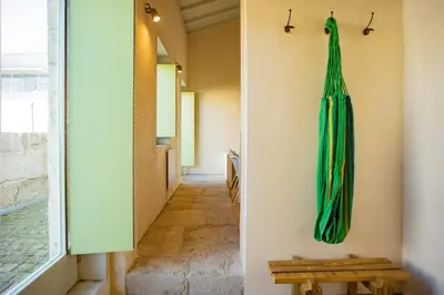 a hallway with a green umbrella hanging on the wall at Estúdio 22 na Boavista, JAMBA House in Porto
