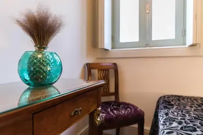 a glass vase sitting on top of a dresser at VIVA Ilda's Home in Porto