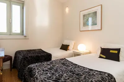 a room with two beds and a window at VIVA Ilda's Home in Porto