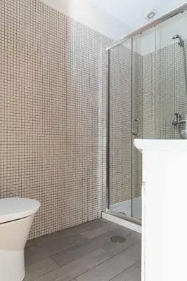 a bathroom with a shower and a toilet and a sink at VIVA Ilda's Home in Porto