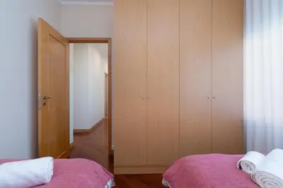 a bedroom with a bed and a door to a closet at Host Wise - Anna Flats in Vila Nova de Gaia