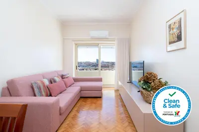 a living room with a couch and a tv at Host Wise - Anna Flats in Vila Nova de Gaia