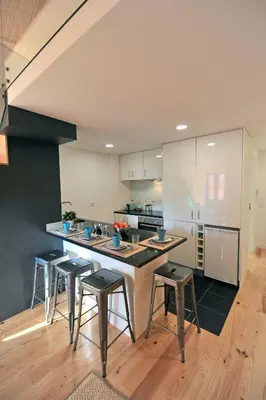 a kitchen with a counter and stools in it at FLH Oporto Wine Cellars Luxury Apartment II in Vila Nova de Gaia