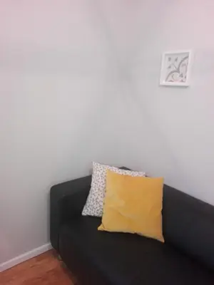 a black couch with a yellow pillow in a room at Secondlove in Porto