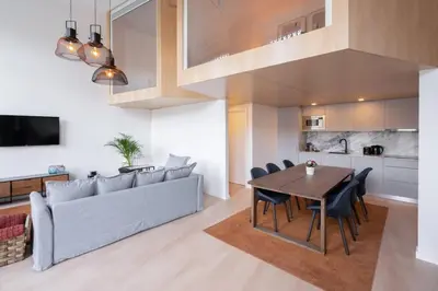 a living room with a table and a couch at Loft Douro Cais da Fontaínha in Vila Nova de Gaia