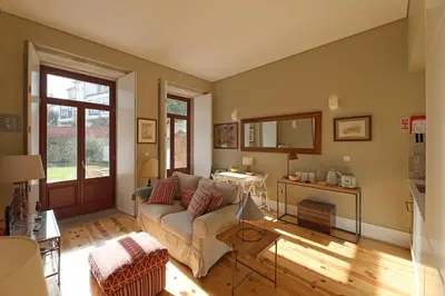a living room with a couch and a table at Oporto MyWish City Central Apartment with Private Garden in Porto