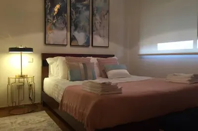 a bedroom with a bed with pillows and a window at Porto bica velha - Carvalhido in Porto