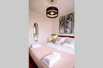 a bedroom with two beds and a pendant light at Porto bica velha - Carvalhido in Porto