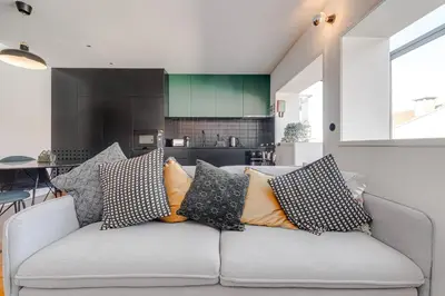 a living room with a gray couch with pillows at Nomad's Family - 2BED Spacious Apartment Gaia in Vila Nova de Gaia