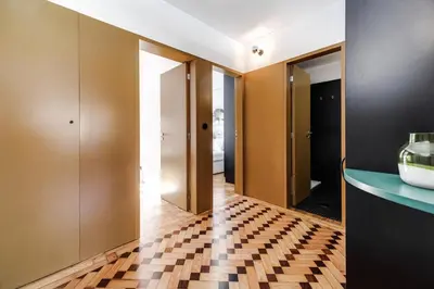 a hallway with wooden doors and a checkered floor at Nomad's Family - 2BED Spacious Apartment Gaia in Vila Nova de Gaia