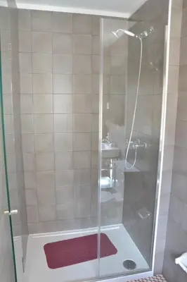 a shower with a glass door in a bathroom at Olival 54 Apartments in Porto