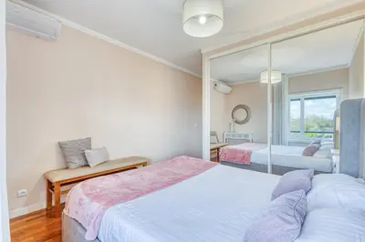a bedroom with two beds and a mirror at Candal Douro in Vila Nova de Gaia