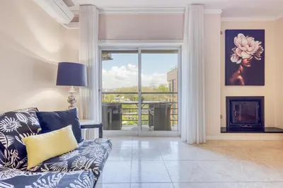 a living room with a couch and a large window at Candal Douro in Vila Nova de Gaia